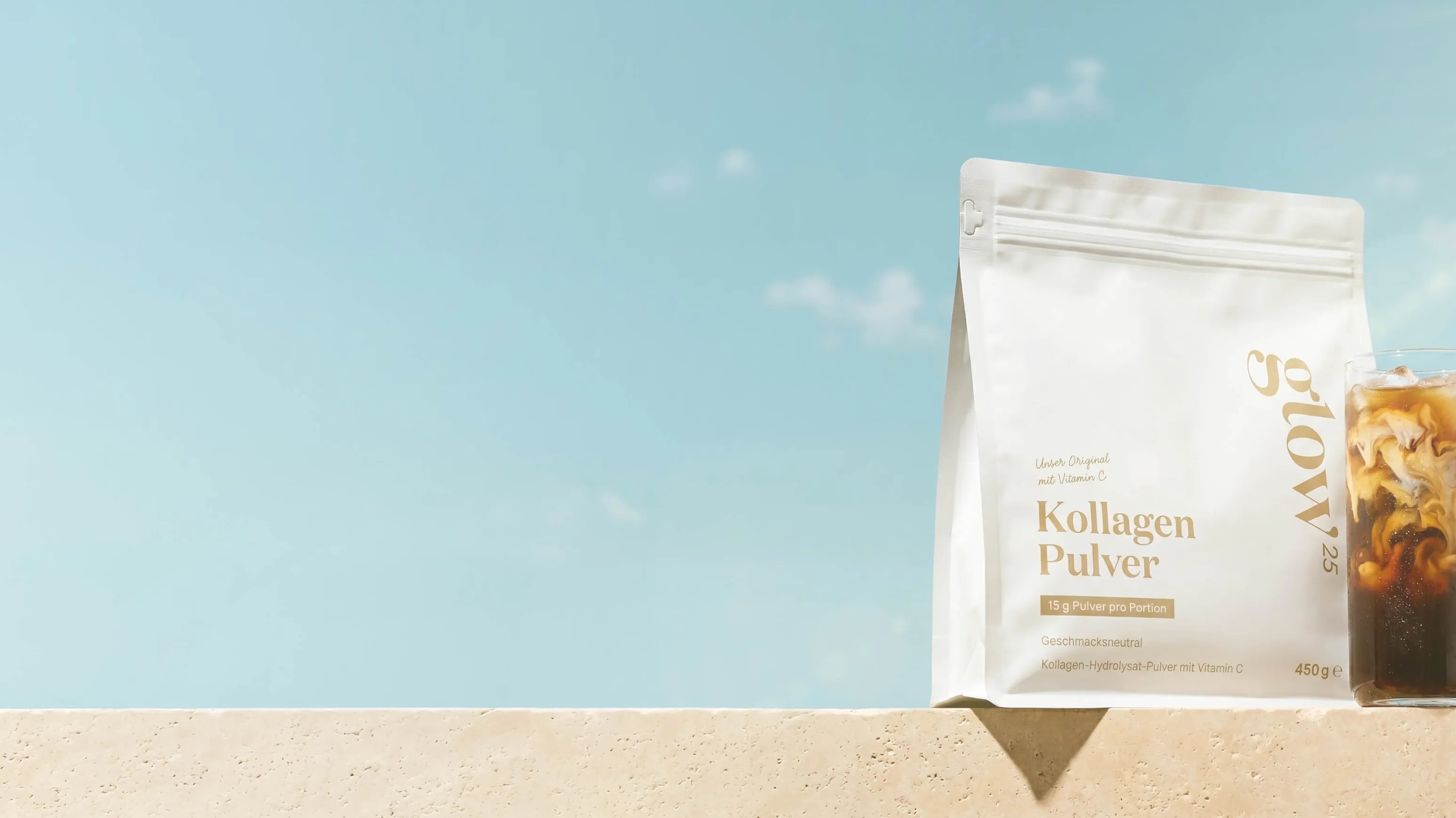 glow25 collagen powder and iced coffee on a wall against a summer sky.