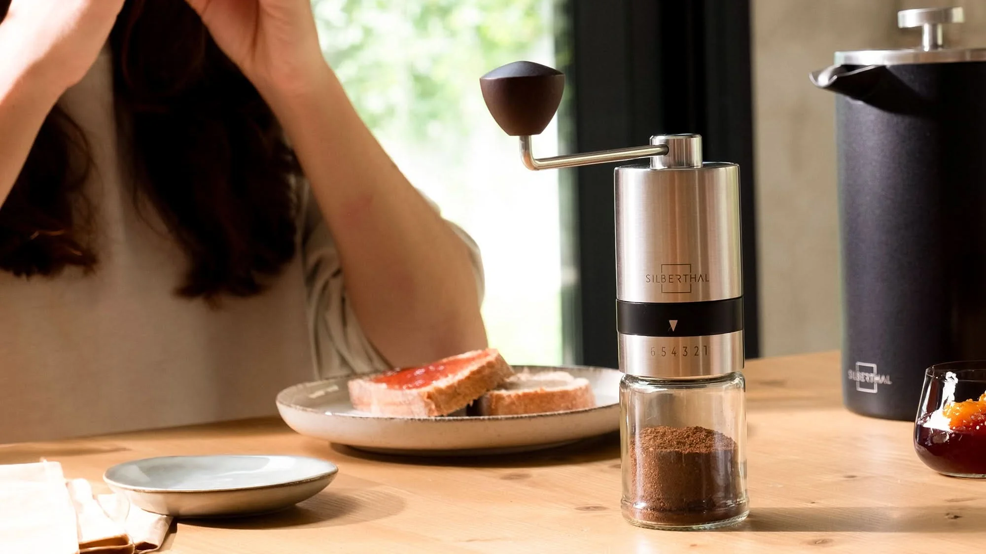 Breakfast table with a Silberthal coffee grinder and plates.