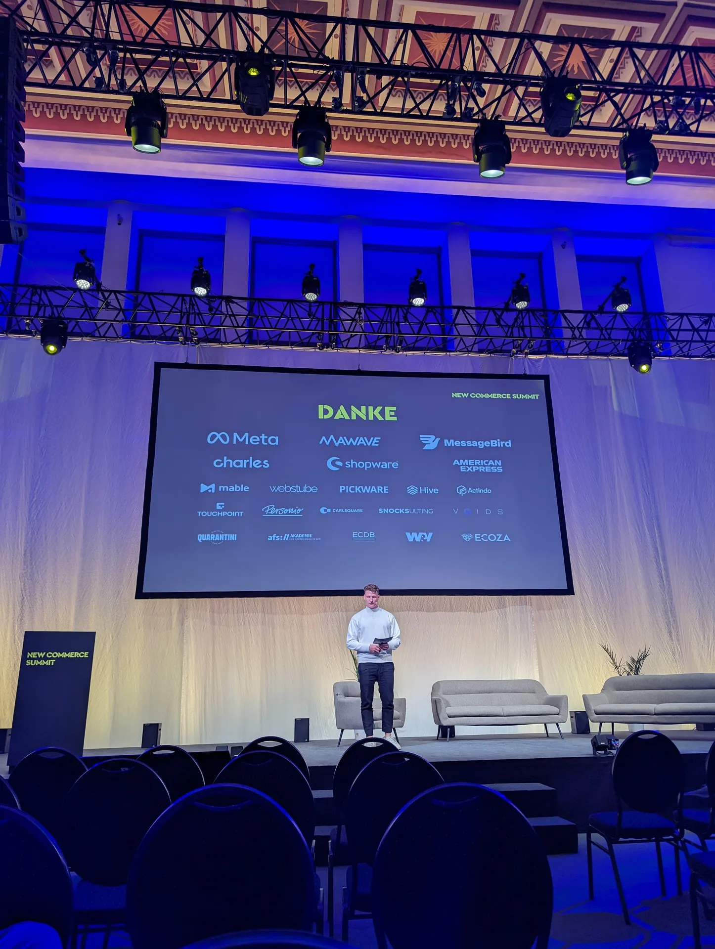 A talk on the conference stage, with the thank-you slide and partner logos on the screen.