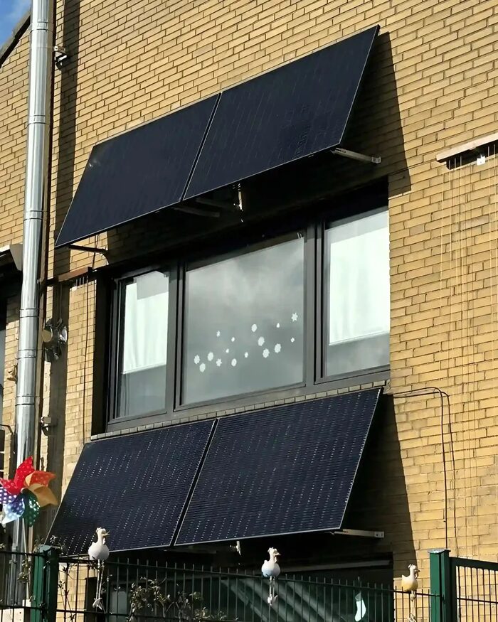 solago, Zwei Solarmodule an der Klinkerfassade eines Wohnhauses