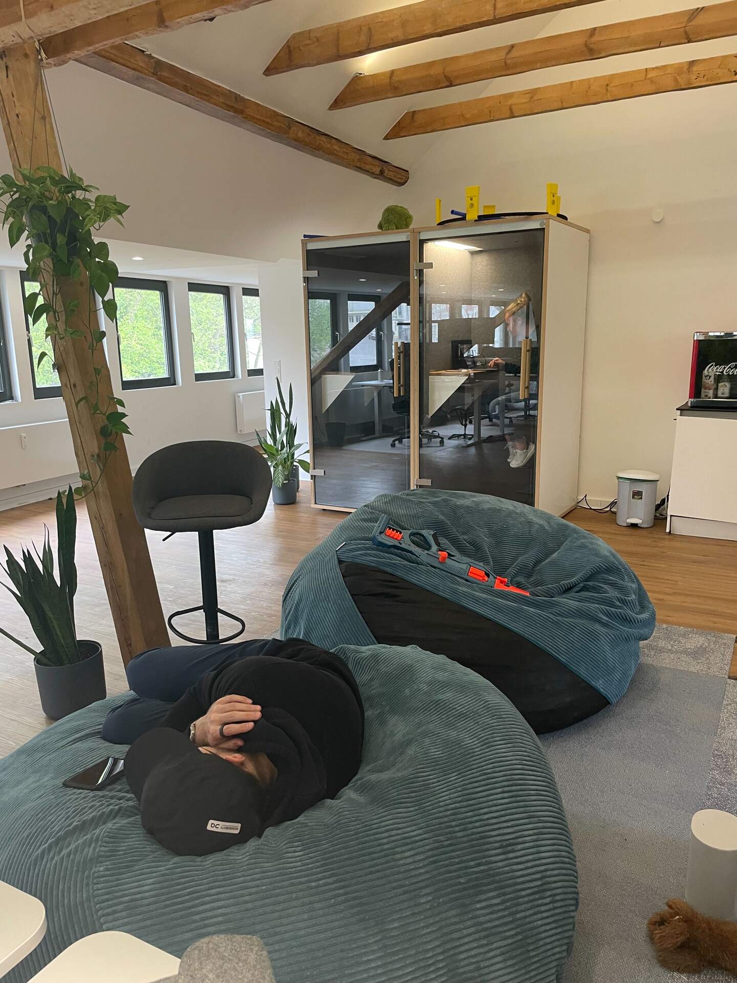 The office lounge corner with beanbags and bar stools.